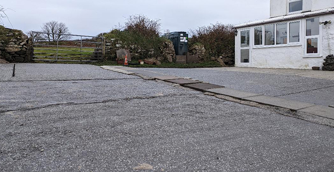 the exterior of a house with a gravel patio and stones